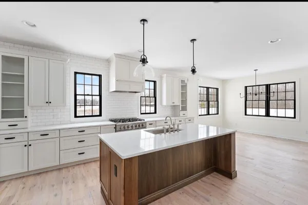 a bathroom with a double vanity sink a mirror and a bathtub