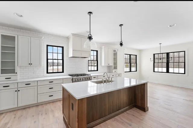 a bathroom with a double vanity sink a mirror and a bathtub