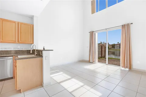 a view of a kitchen with refrigerator and sink