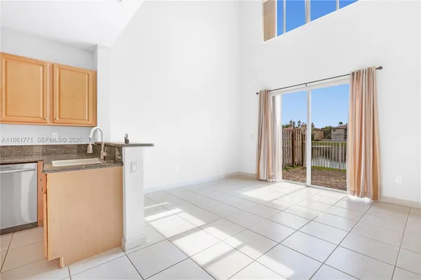 a view of a kitchen with refrigerator and sink