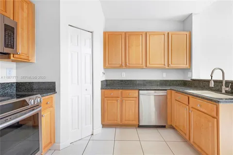 a kitchen with stainless steel appliances granite countertop a stove and a sink