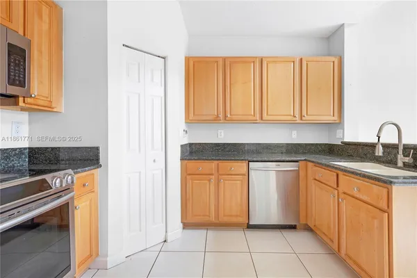 a kitchen with stainless steel appliances granite countertop a stove and a sink