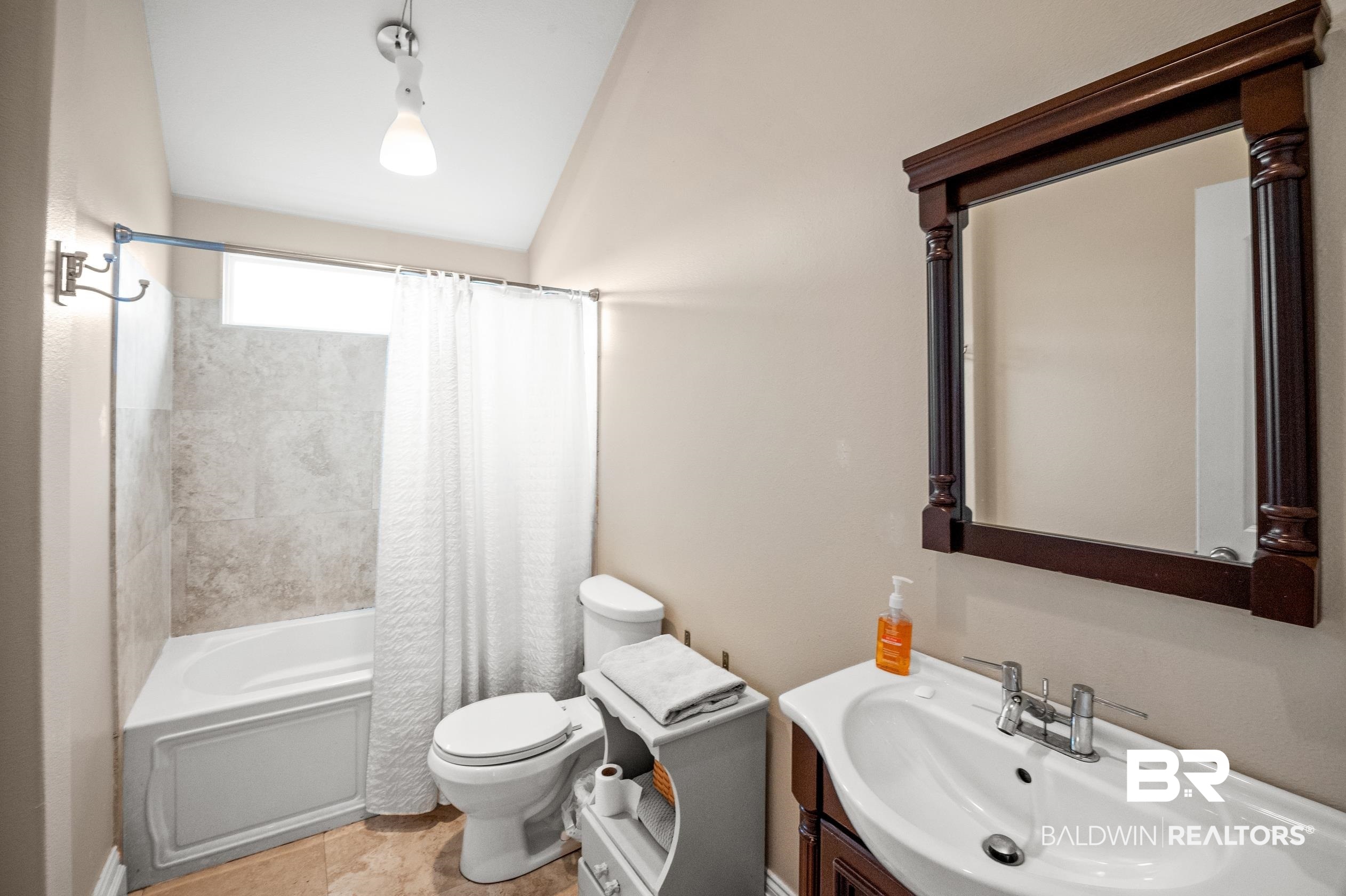 13358 County Road 91 Elberta, AL 36530 - Photo 18 of 47 Full bathroom with vanity, vaulted ceiling, toilet, and shower / bath combo