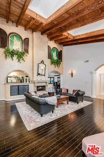 a reading room with furniture and a wooden floor