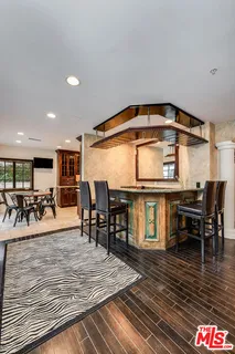 a kitchen with stainless steel appliances granite countertop a stove a sink a table and chairs