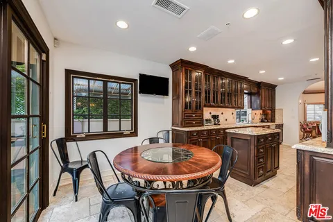 a dining room with a wooden table and chairs