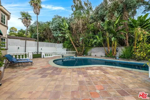 a view of a patio with swimming pool table and chairs