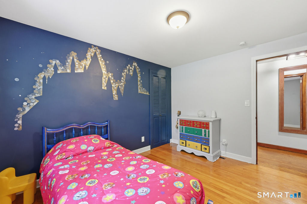 630 South Elm Street Wallingford, CT 06492 - Photo 21 of 30 a bedroom with a bed and a chandelier
