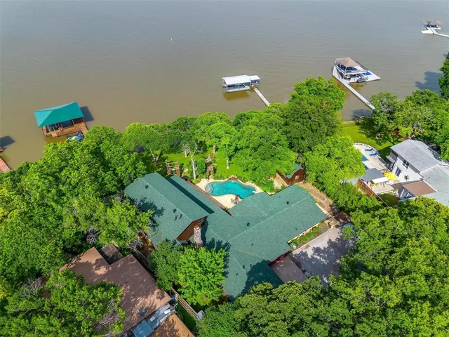 an aerial view of a house with a yard and outdoor seating