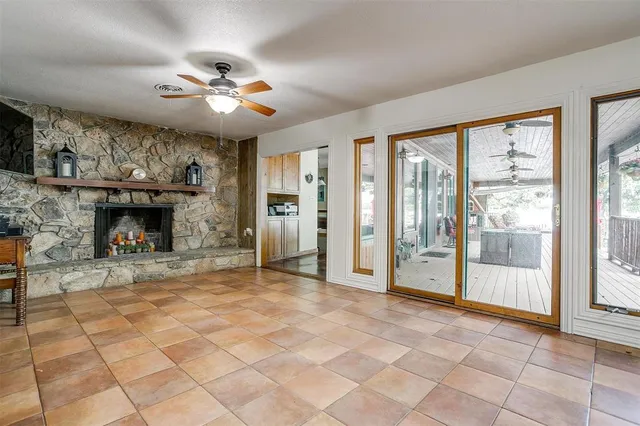 a room with wooden floors pool table and a chandelier