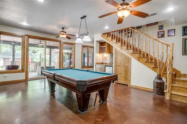 a bathroom with a granite countertop sink mirror vanity and next to a window