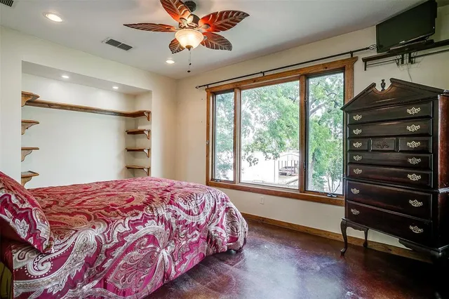 a bedroom with a large bed and a large window