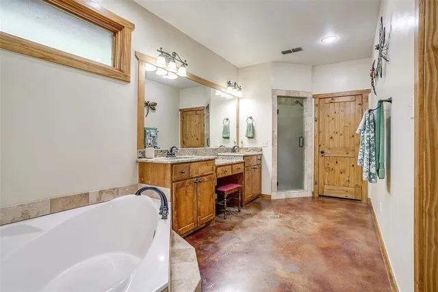 a bathroom with a sink tub shower and a mirror