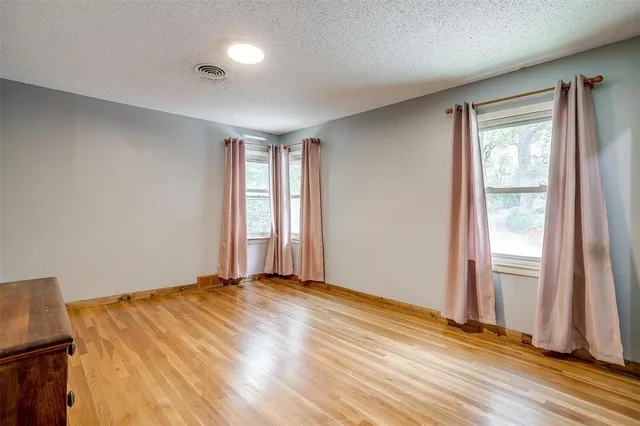 a bathroom with a granite countertop toilet a sink and a mirror