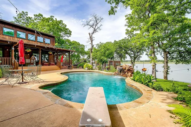 a view of a patio with table and chairs and potted plants