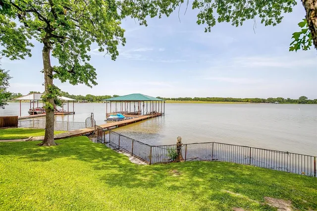 a view of a balcony with wooden floor and lake view