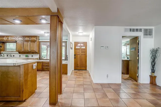 a view of a refrigerator in kitchen and a windows