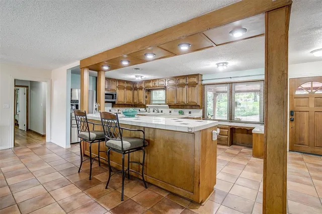 a kitchen with kitchen island granite countertop wooden cabinets and counter space