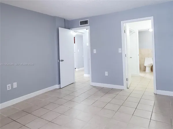 a view of an empty room and closet area