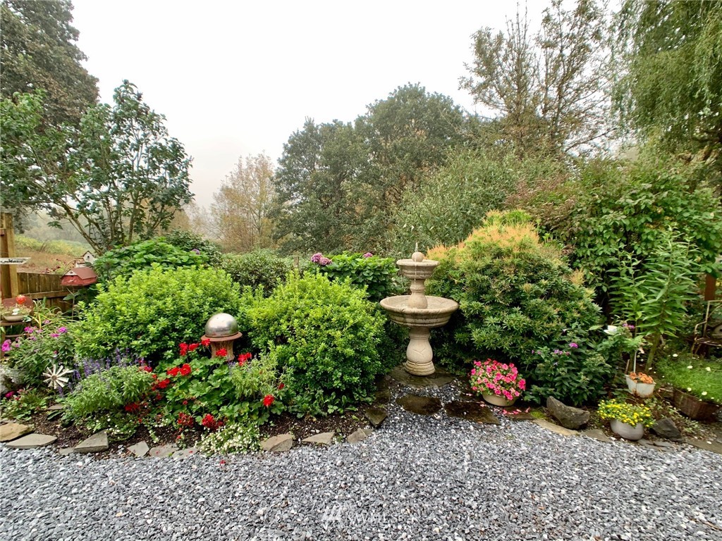 8123 James Road Southwest Rochester, WA 98579 - Photo 22 of 38 a view of a garden with fountain