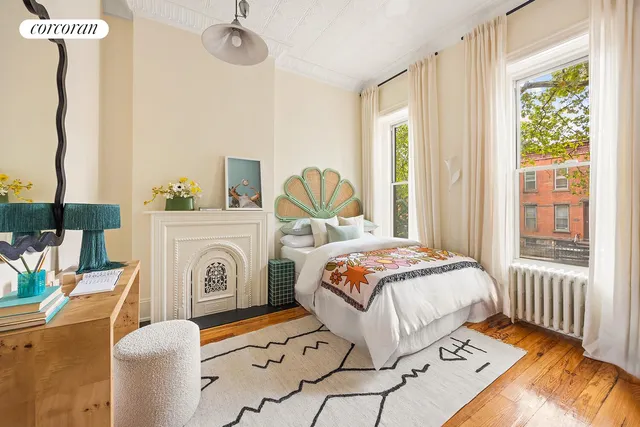 a bedroom with a bed and a painting on the wall