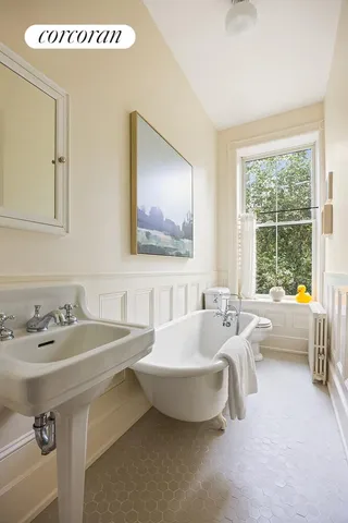 a living room with furniture a window and a flat screen tv