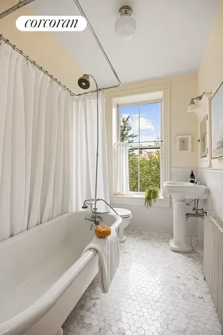 a spacious bathroom with a tub a sink and mirror