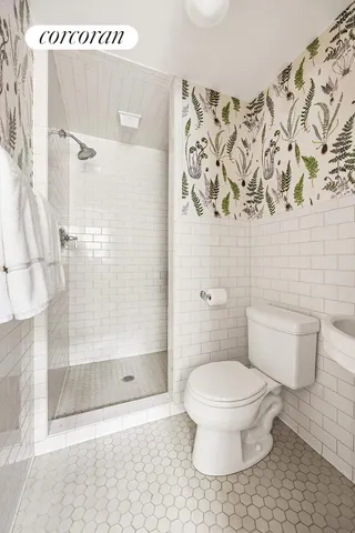 a bathroom with a tub a sink and a window