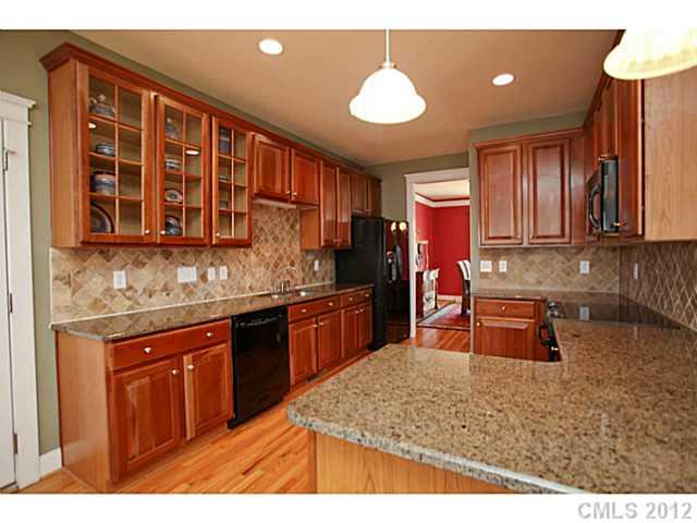 213 Mills Lane Fort Mill, SC 29708 - Photo 4 of 16 a kitchen with stainless steel appliances granite countertop wooden cabinets a oven and granite counter tops