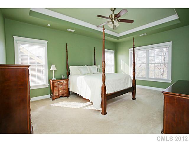 213 Mills Lane Fort Mill, SC 29708 - Photo 6 of 16 a spacious bedroom with a bed and a chandelier