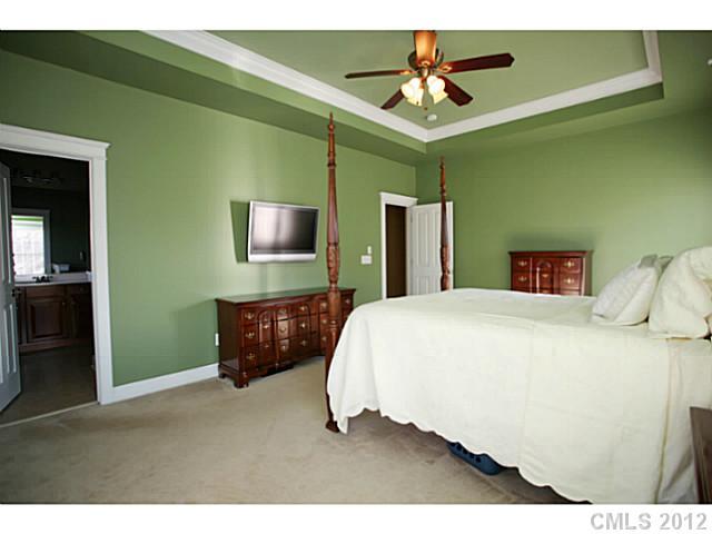 213 Mills Lane Fort Mill, SC 29708 - Photo 7 of 16 a bedroom with a bed and a chandelier