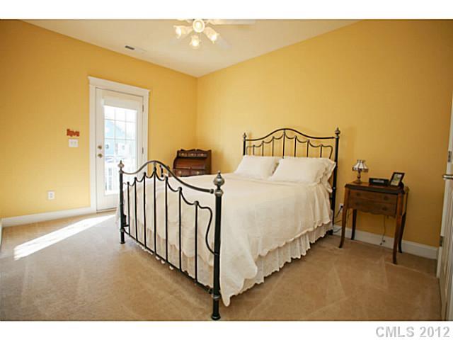 213 Mills Lane Fort Mill, SC 29708 - Photo 10 of 16 a view of a bedroom with a bed and wooden floor