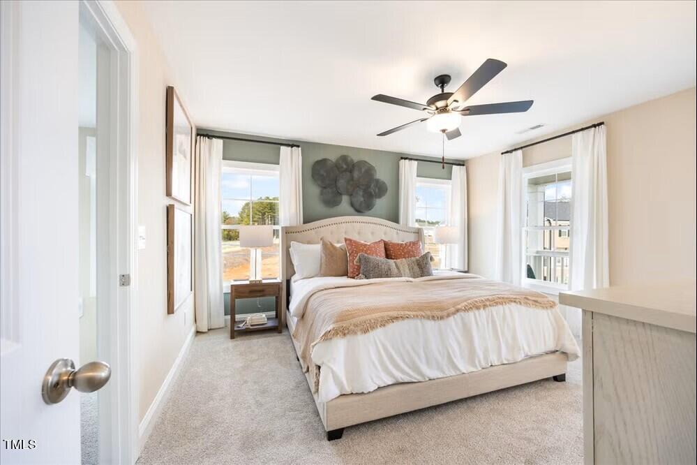 527 Forestville Road Wake Forest, NC 27587 - Photo 15 of 47 a bedroom with a bed and a large window