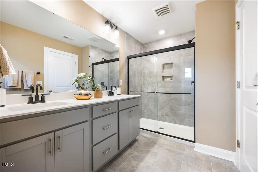 527 Forestville Road Wake Forest, NC 27587 - Photo 16 of 47 a bathroom with a shower sink and mirror