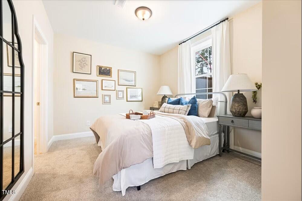 527 Forestville Road Wake Forest, NC 27587 - Photo 2 of 47 a bedroom with a bed and a window