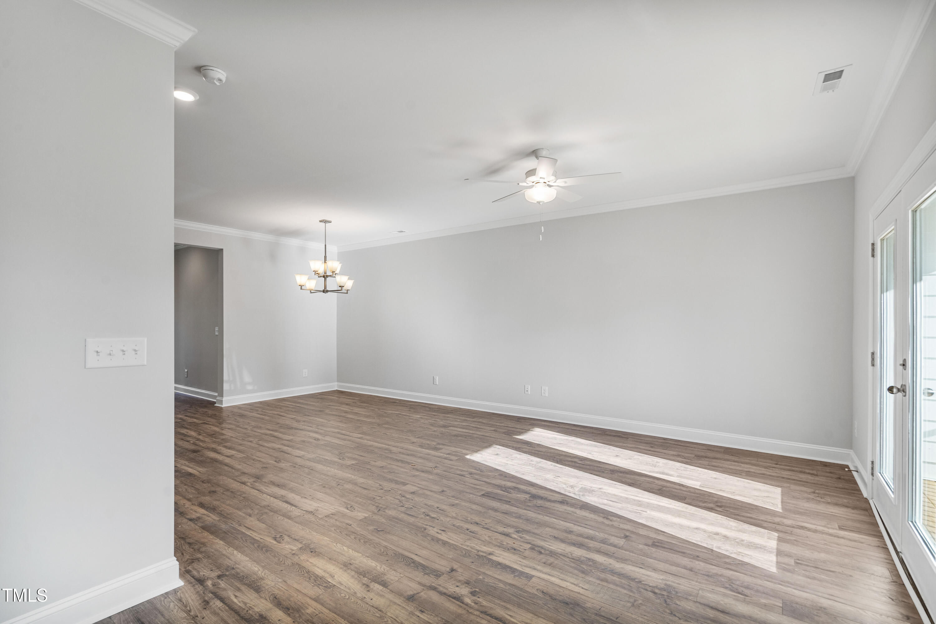 527 Forestville Road Wake Forest, NC 27587 - Photo 23 of 47 an empty room with wooden floor and window