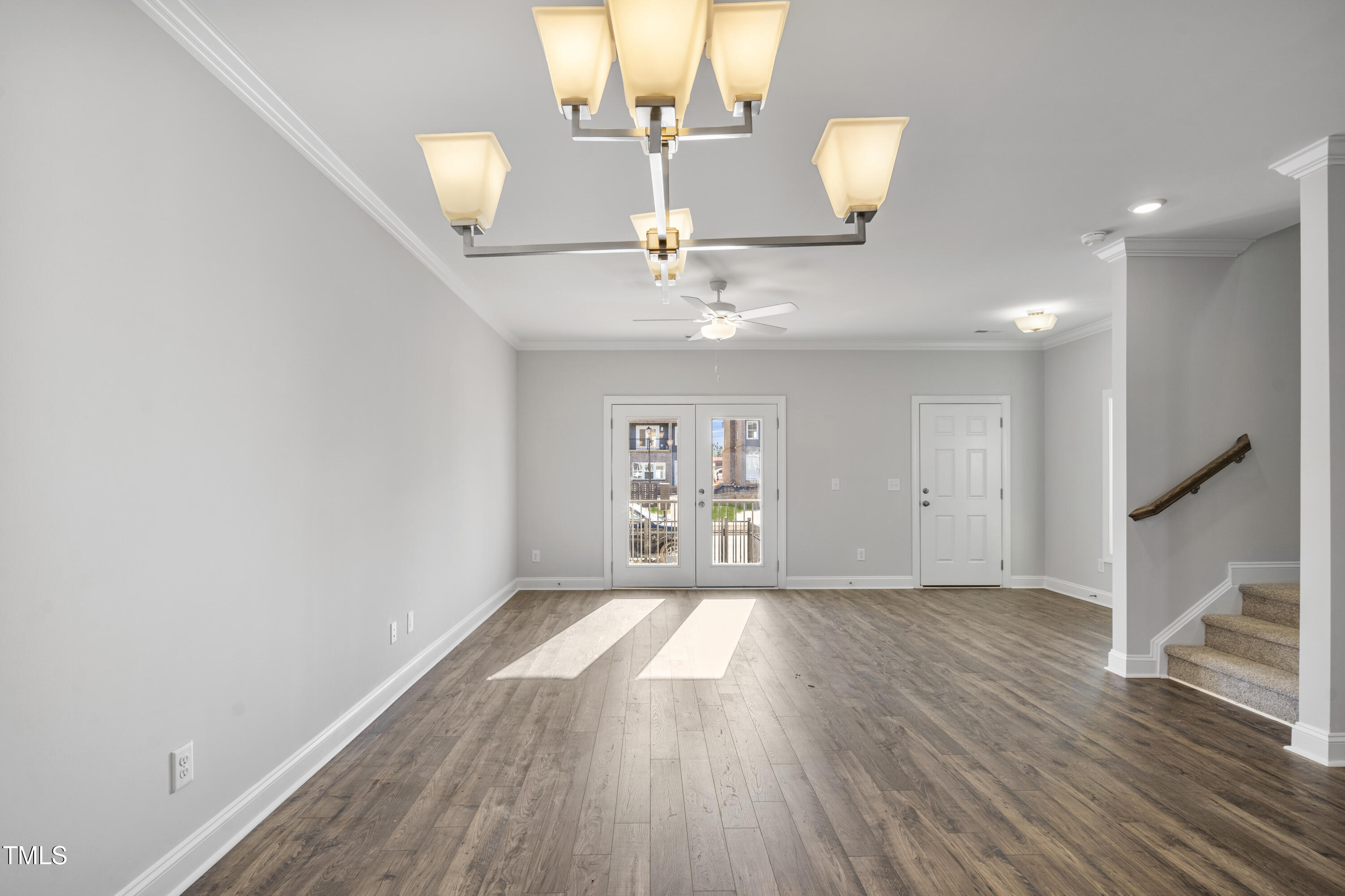 527 Forestville Road Wake Forest, NC 27587 - Photo 27 of 47 a view of a hallway with wooden floor and chandelier