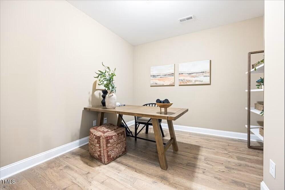 527 Forestville Road Wake Forest, NC 27587 - Photo 3 of 47 a workspace with furniture and wooden floor