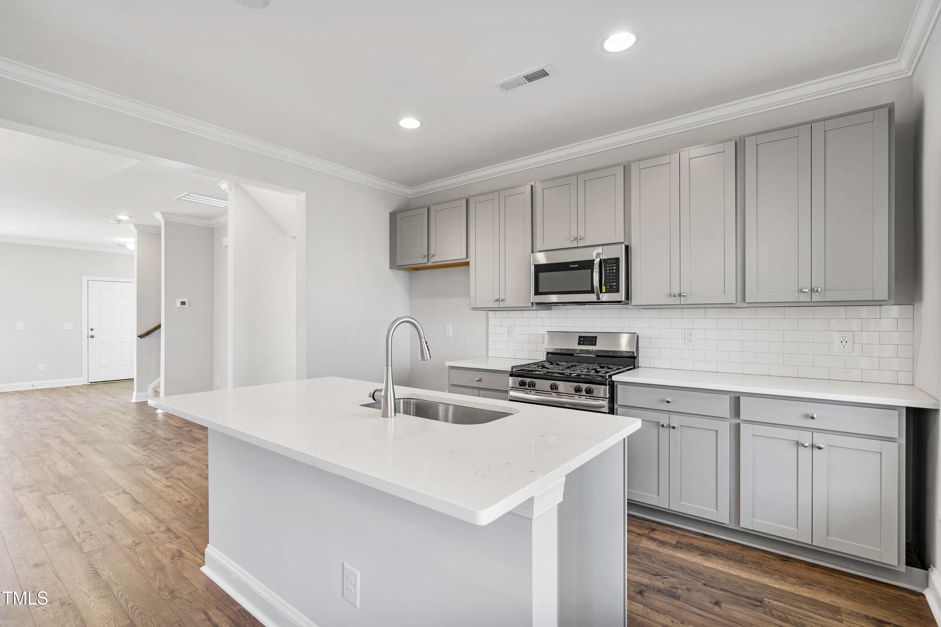 527 Forestville Road Wake Forest, NC 27587 - Photo 31 of 47 a kitchen with a sink a stove a microwave and cabinets