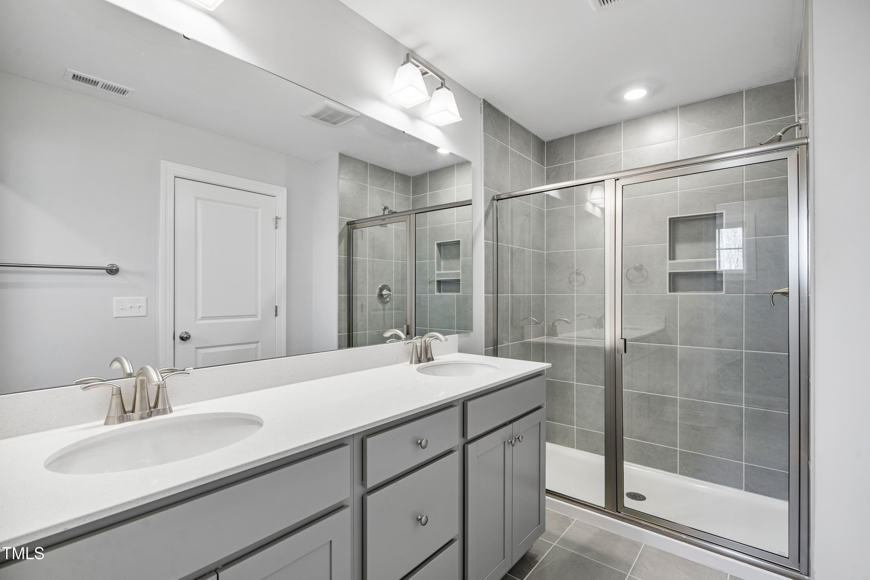 527 Forestville Road Wake Forest, NC 27587 - Photo 46 of 47 a bathroom with a shower sink and mirror