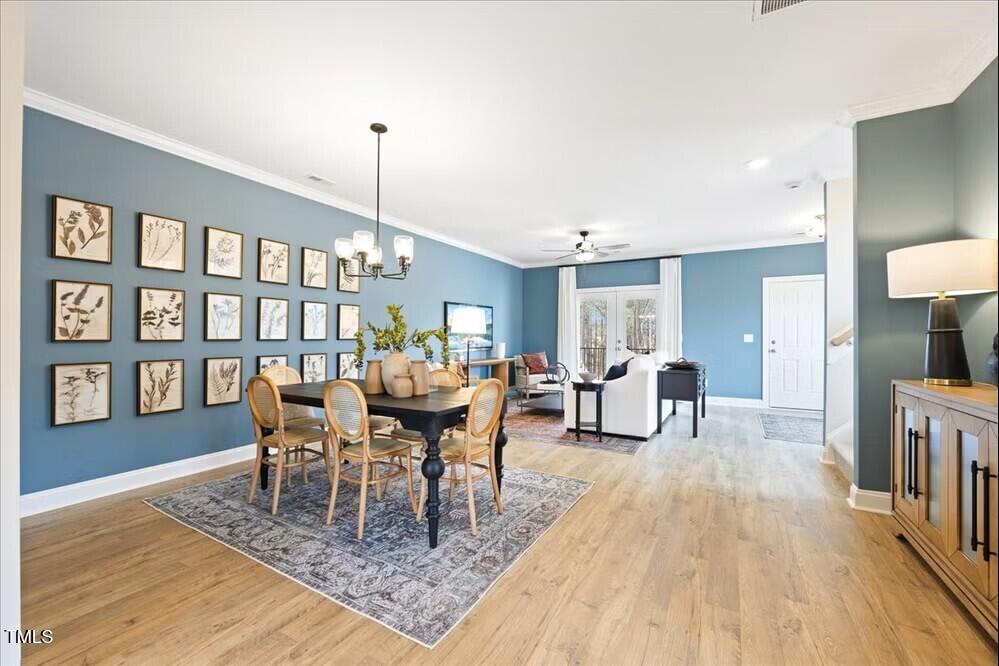527 Forestville Road Wake Forest, NC 27587 - Photo 9 of 47 a living room with furniture a rug and a wooden floor