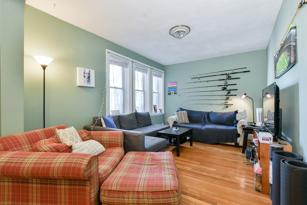 1666 Commonwealth Avenue, Unit 33 Boston, MA 02135 - Photo 1 of 11 a bedroom with furniture and a flat screen tv
