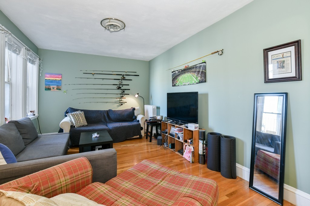 1666 Commonwealth Avenue, Unit 33 Boston, MA 02135 - Photo 2 of 11 a living room with furniture and a flat screen tv