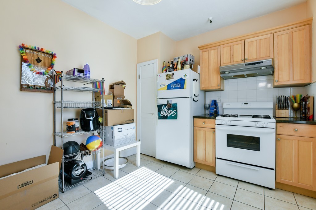 1666 Commonwealth Avenue, Unit 33 Boston, MA 02135 - Photo 6 of 11 a view of kitchen and utility room with baby toys