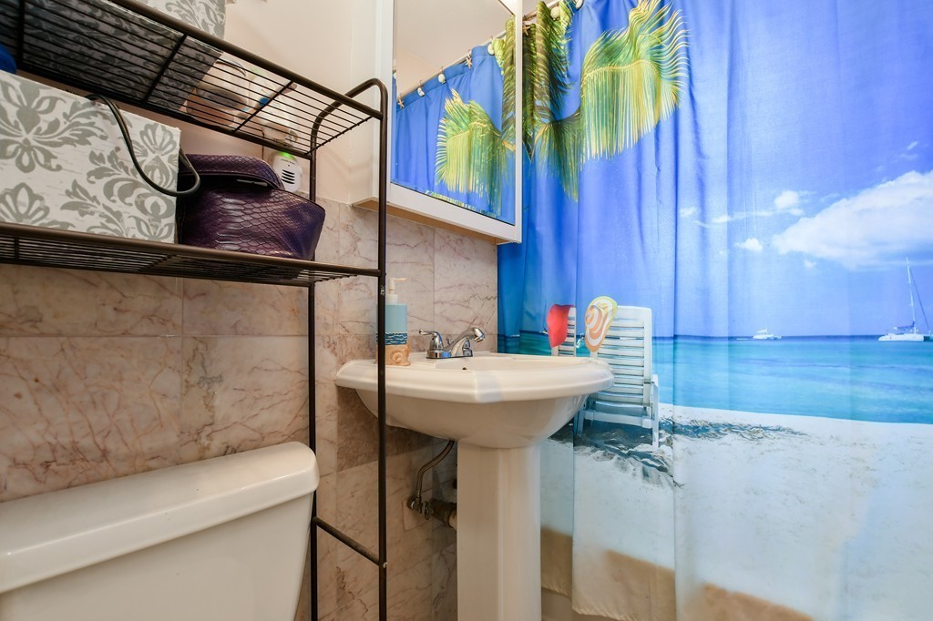1666 Commonwealth Avenue, Unit 33 Boston, MA 02135 - Photo 8 of 11 a bathroom with a sink and a mirror
