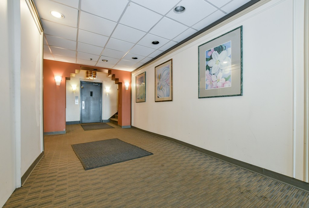1666 Commonwealth Avenue, Unit 33 Boston, MA 02135 - Photo 9 of 11 a view of a hallway with wooden floor