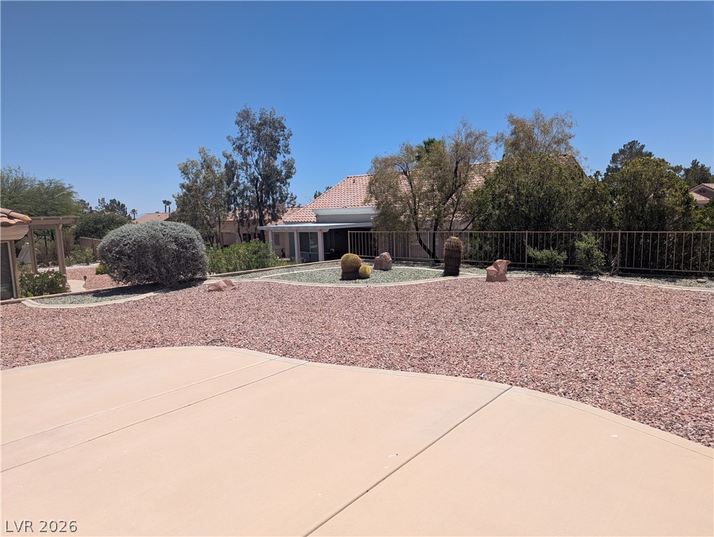 9433 Quail Ridge Drive Las Vegas, NV 89134 - Photo 21 of 23 A spacious backyard with desert landscaping and a paved patio awaits outdoor enjoyment.