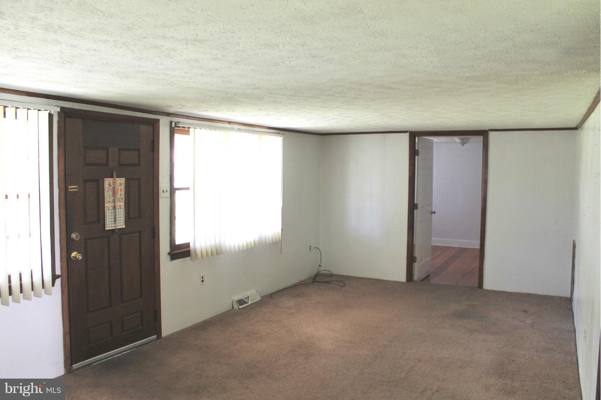 Front door surrounded by large windows.