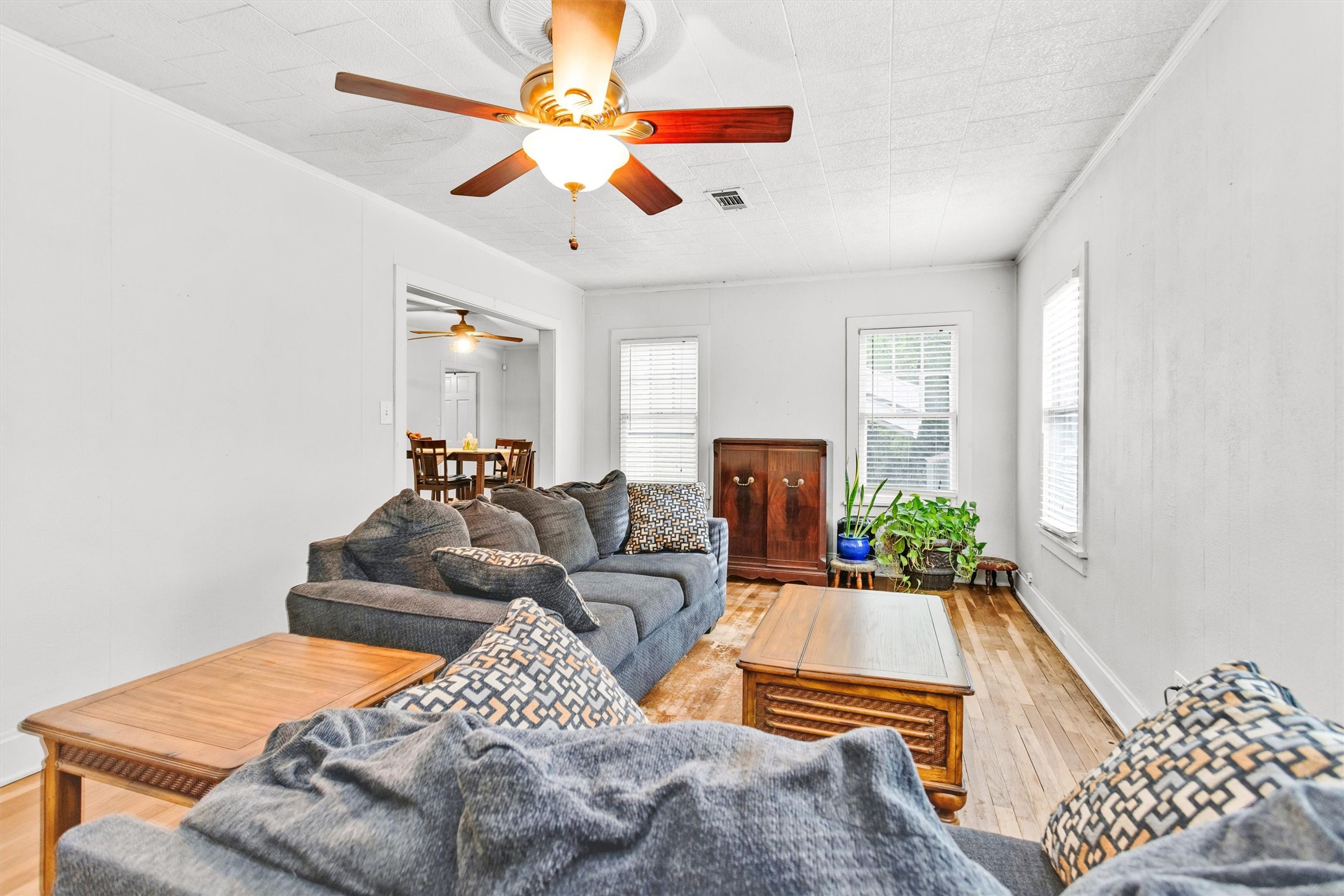 1720 18th Street Huntsville, TX 77340 - Photo 9 of 37 a living room with furniture and a chandelier