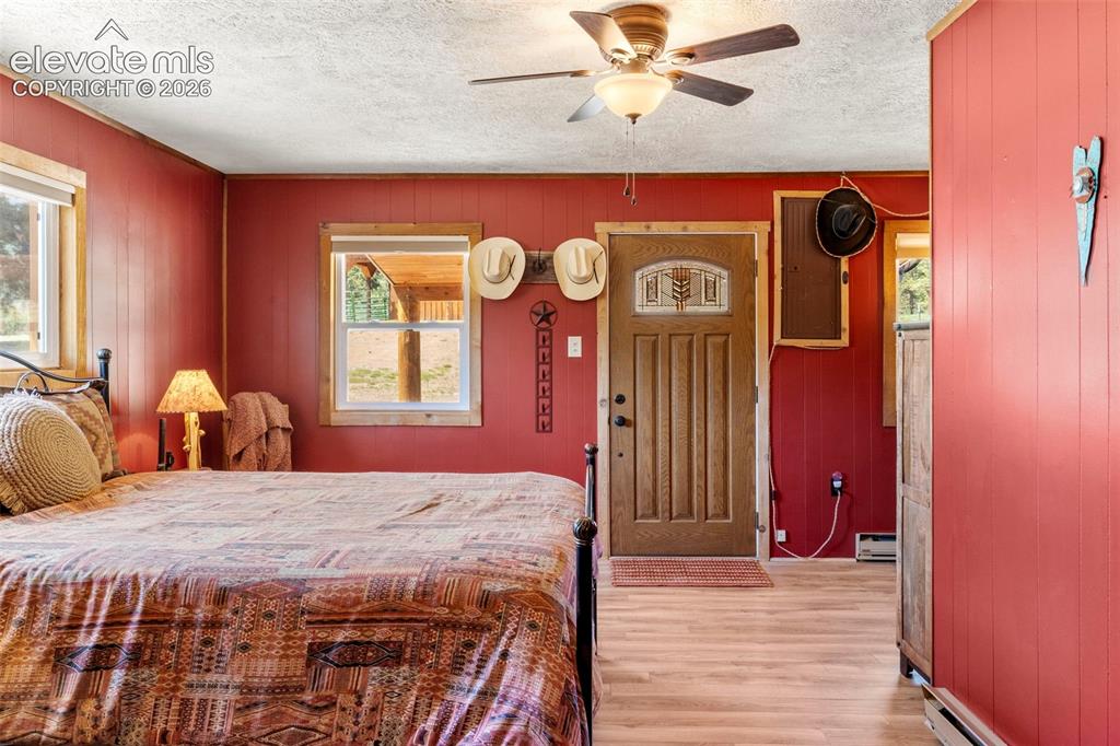 546 Pulver Road Lake George, CO 80827 - Photo 14 of 45 a bedroom with a bed and a chandelier
